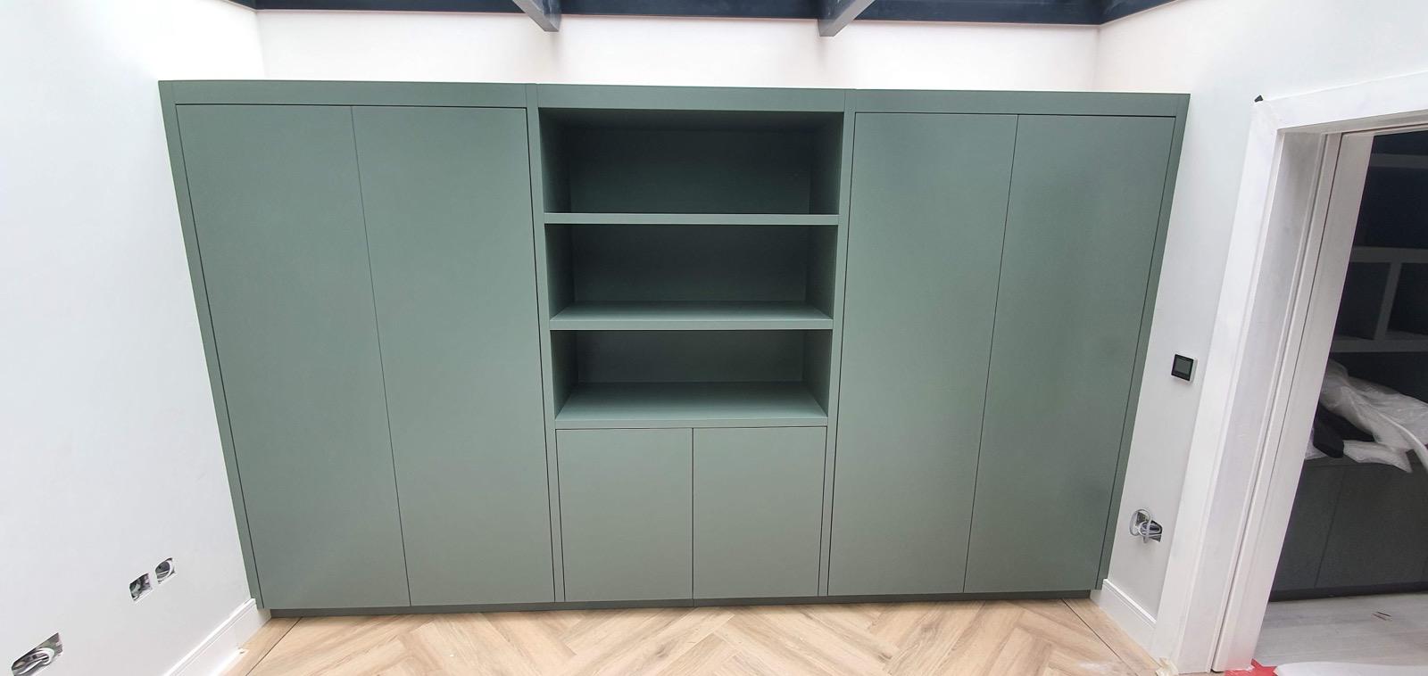 Sage green media unit with open shelving