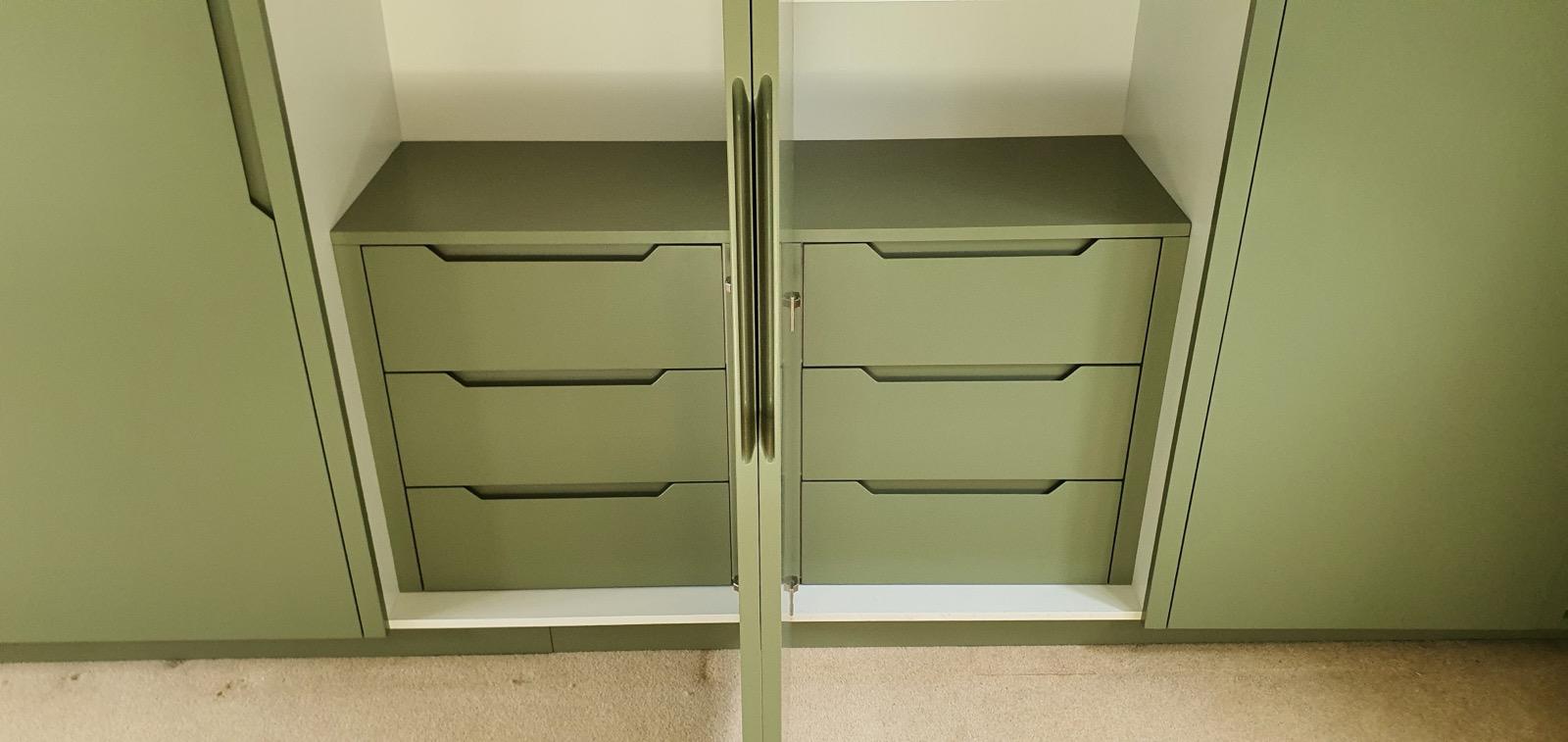Sage green cabinet interior showing drawer details
