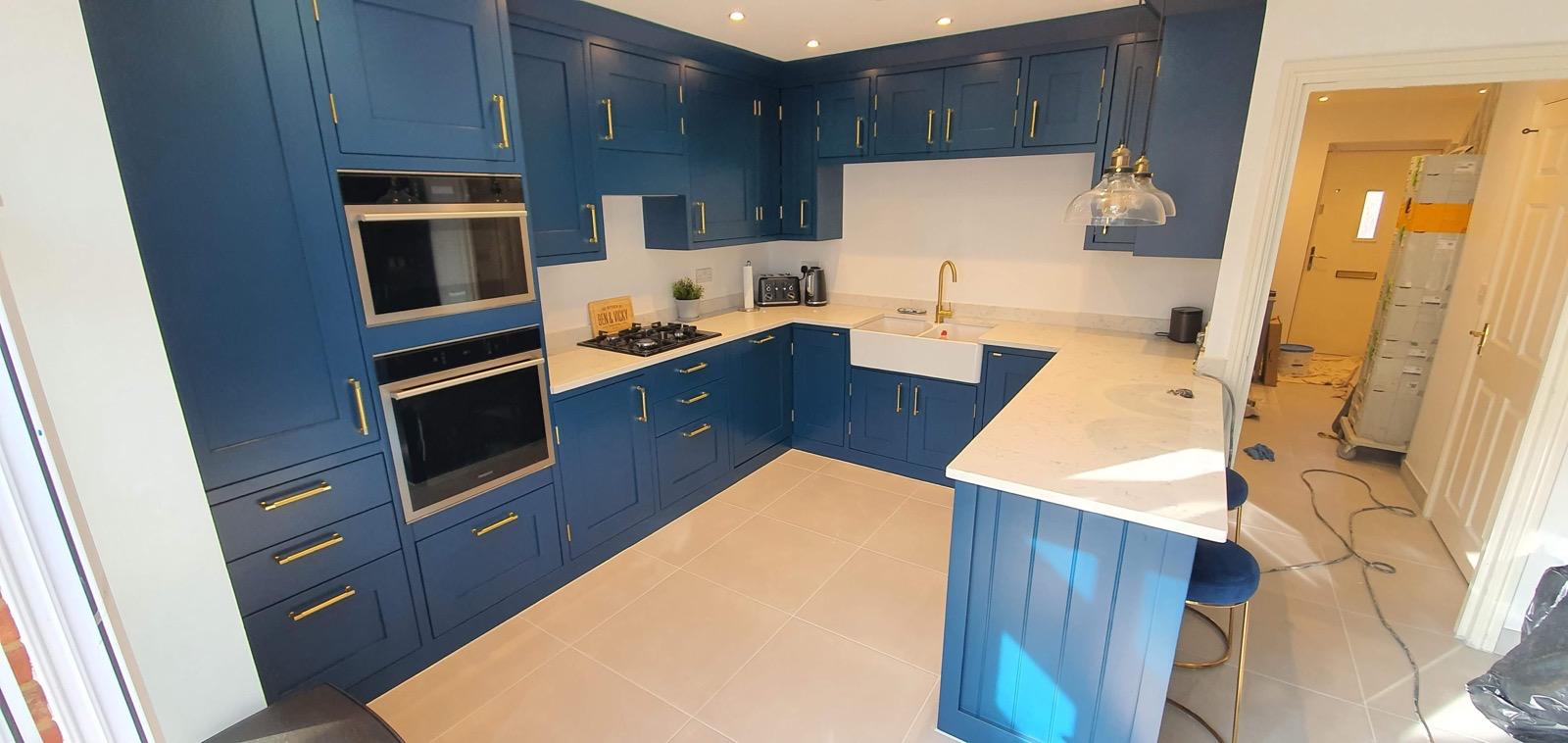 Blue kitchen with island and bar seating