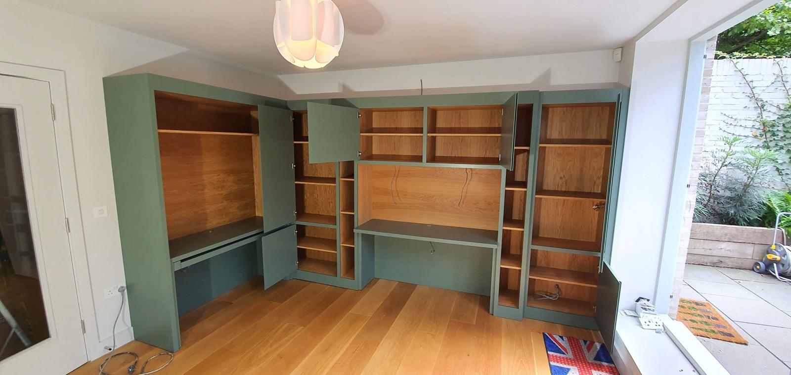 Sage green fitted office unit with oak shelving open