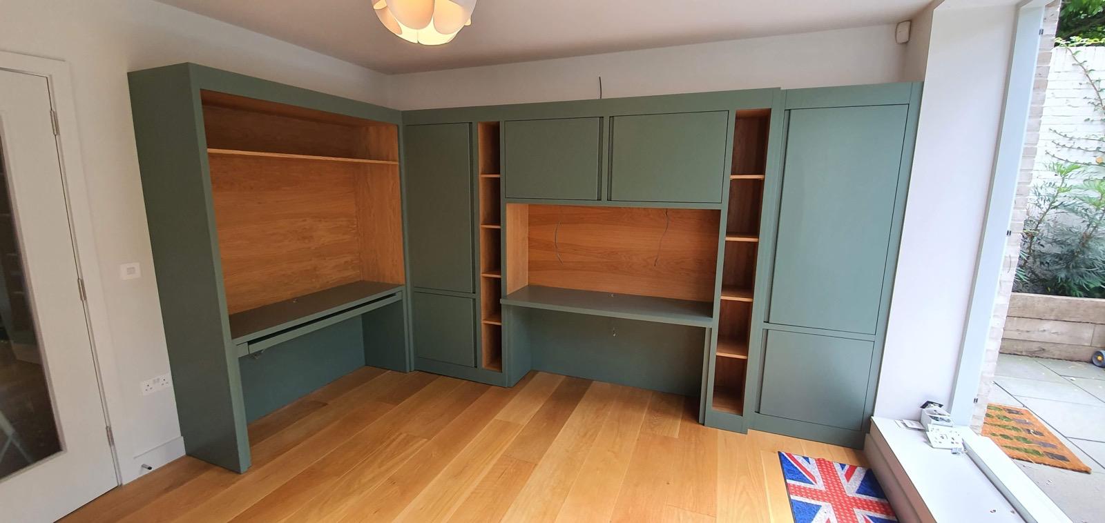 Sage green built-in home office with natural wood accent