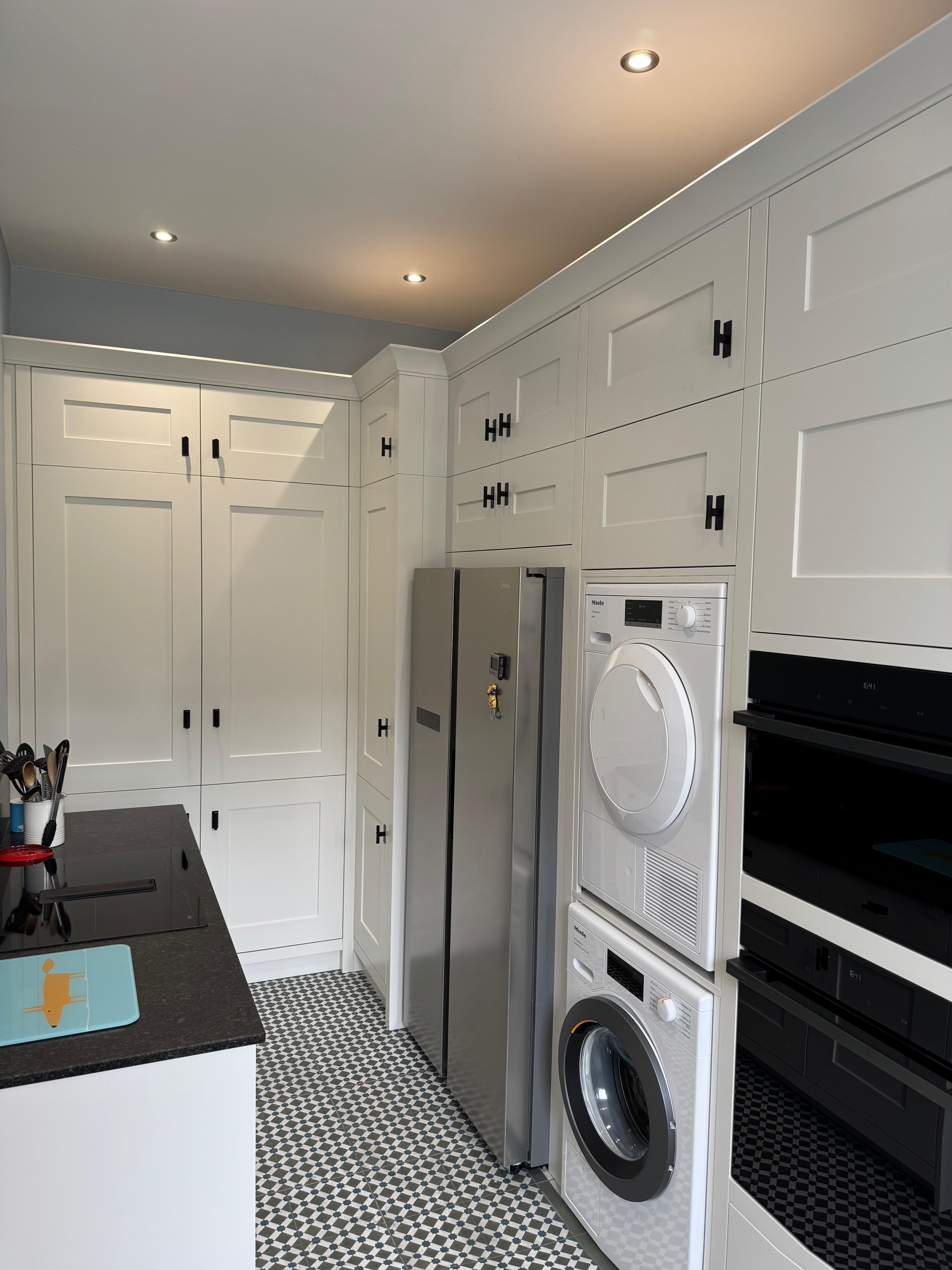 White kitchen with integrated washer and dryer