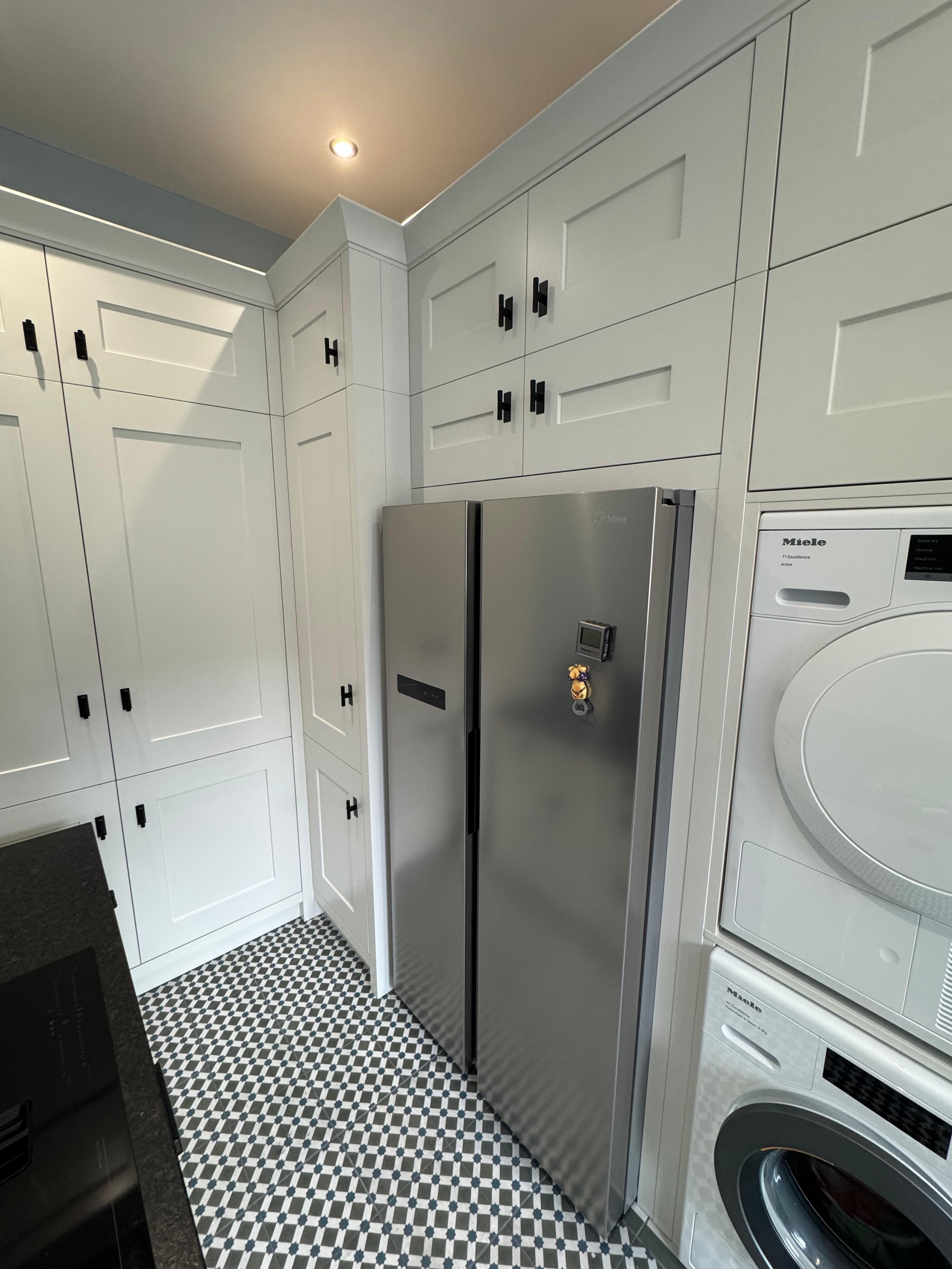 Kitchen with geometric floor tiles and integrated appliances